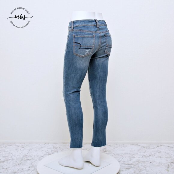 American Eagle Super Stretch Low Waist Distressed Raw Hem Jeggings - Picture 4 of 14